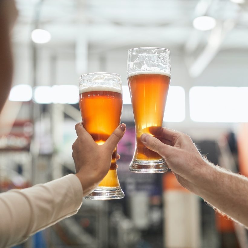 workers-holding-craft-beer-glasses-at-brewery.jpg
